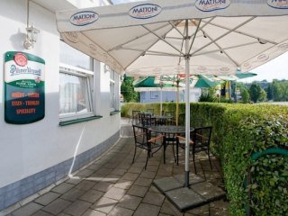 Terasa restaurace V Oblouku se slunečníky za slunečného letního dne